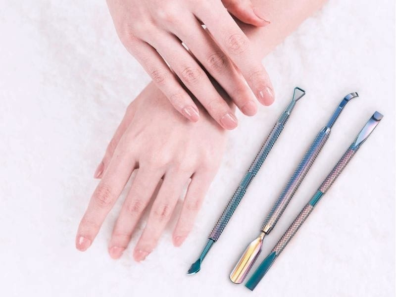 How do you use a cuticle nail pusher with safety