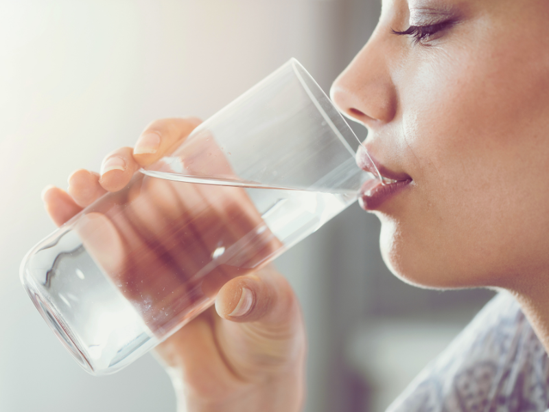 A person drinking filtered water for hydration