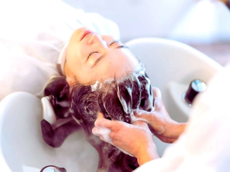 Shampooing process showing how different shampoos impact hair health, from cleansing to potential effects on scalp and strands.