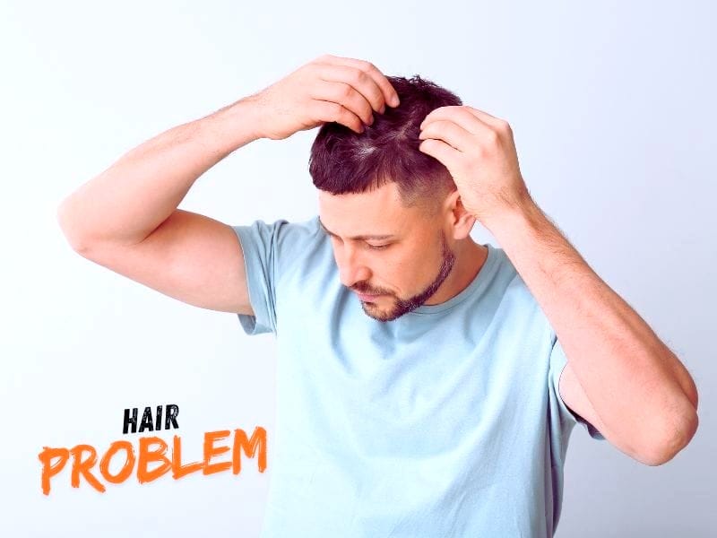 Concerned man checks scalp in mirror, noticing early signs of hair thinning or bald spots