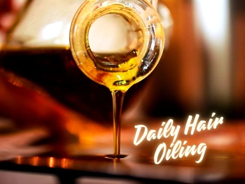 Golden hair oil pouring from a glass bottle. Text: 'Daily Hair Oiling' in glowing script font.