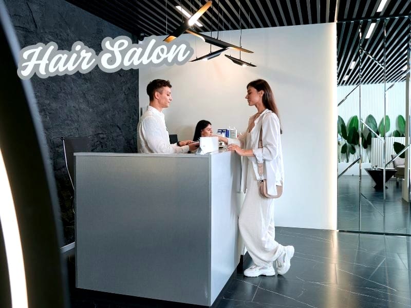Modern hair salon reception with client check-in, highlighting a focus on client retention strategy.
