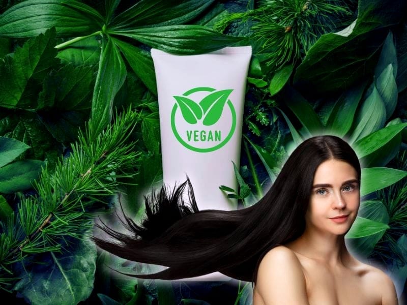 oman with shiny black hair using vegan herbal haircare product surrounded by green botanicals.