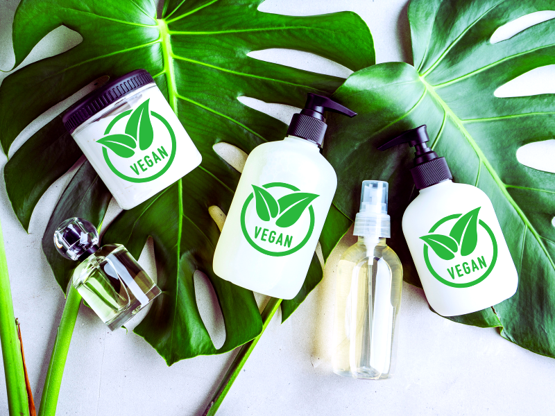 Vegan haircare products on green leaves—natural, clean beauty solutions for sensitive, oily scalps.