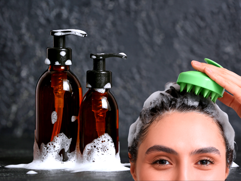 Woman using scalp brush beside foaming shampoo bottles—free from harsh ingredients like sulfates.