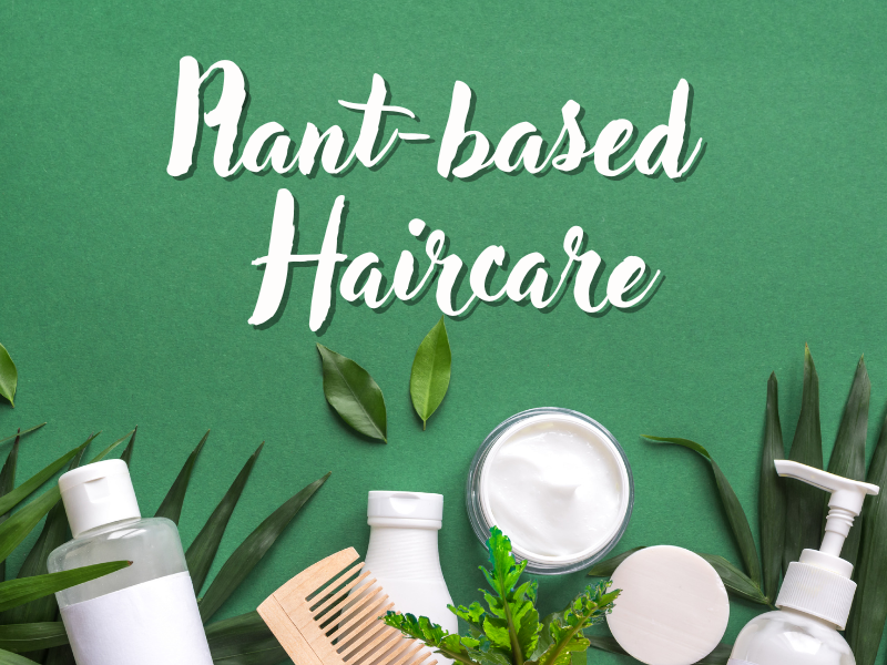 Plant-based haircare products with leaves on green background—natural beauty for scalp and hair health.