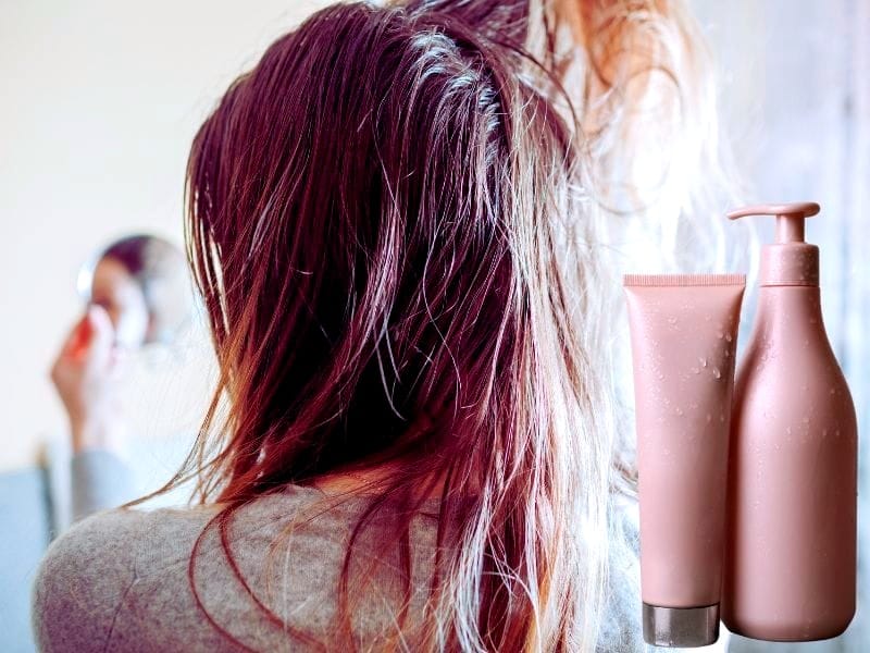 Woman examining her wet, thinning hair in a mirror, with shampoo and conditioner bottles in the foreground.