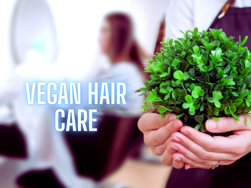 Eco-conscious salon professional promoting vegan hair care with greenery in hand.