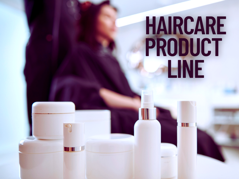 Professional haircare product line displayed in a salon setting with a client receiving hair services in the background