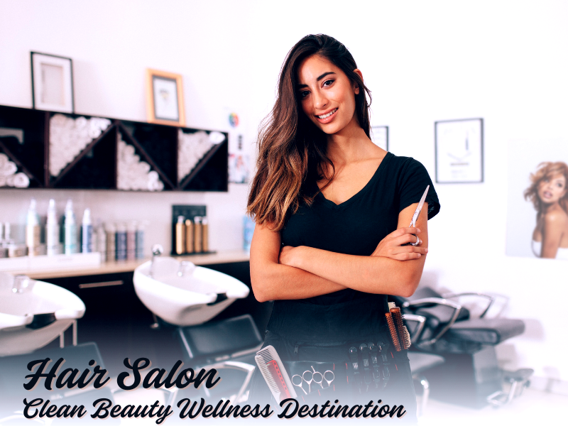 Confident hairstylist in salon promoting clean beauty, wellness, and vegan scalp detox services.