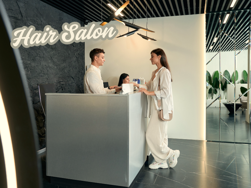 Modern hair salon reception with smiling clients and staff, highlighting client loyalty and care.