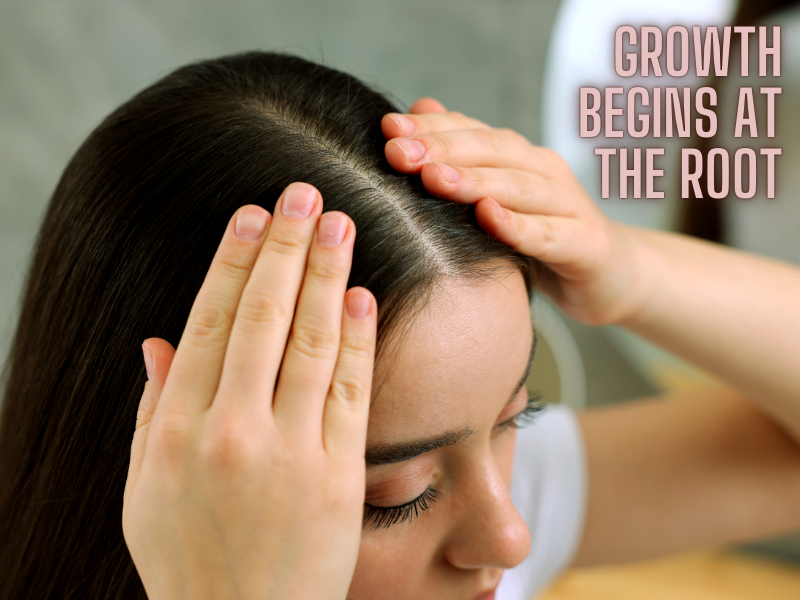 Woman massaging scalp – healthy hair growth begins at the root with proper scalp care and nourishment.